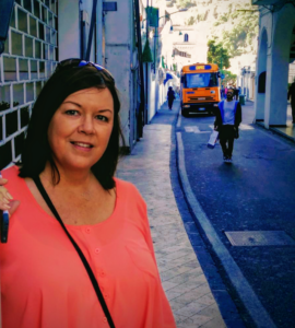 Debbie Burney standing against a wall in a small alcove.